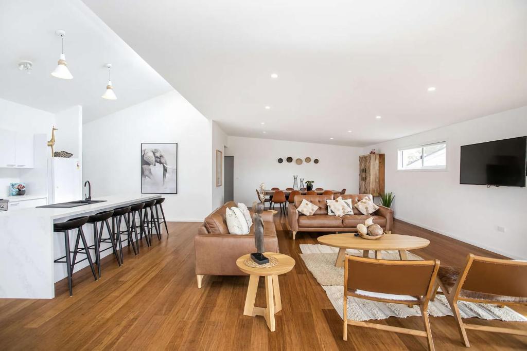 a living room with a couch and a table at Ocean Blue in Ulladulla