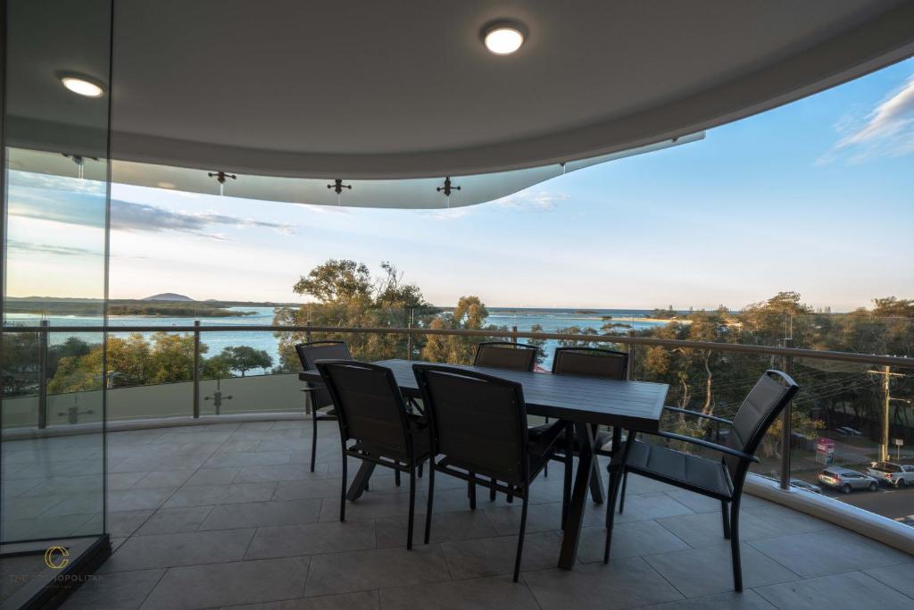 a dining room with a table and chairs on a balcony at THE COSMOPOLITAN COTTON TREE Unit 10509 COTTON TREE CORNER in Maroochydore