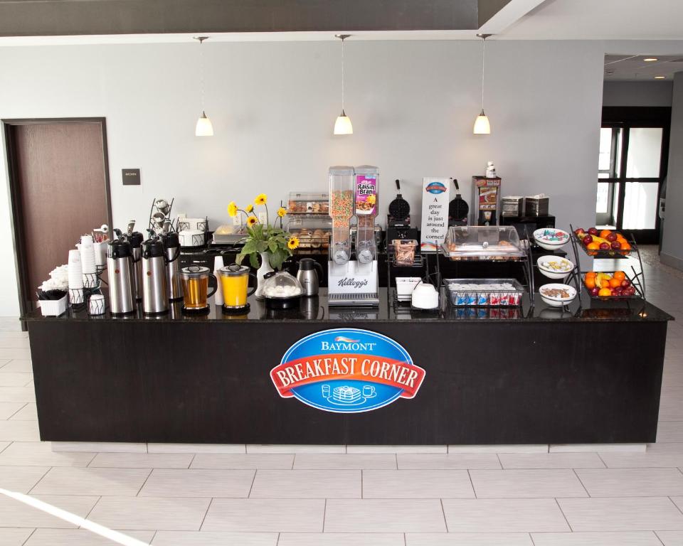 a black counter with a sign on top of it at Baymont by Wyndham Rapid City in Rapid City