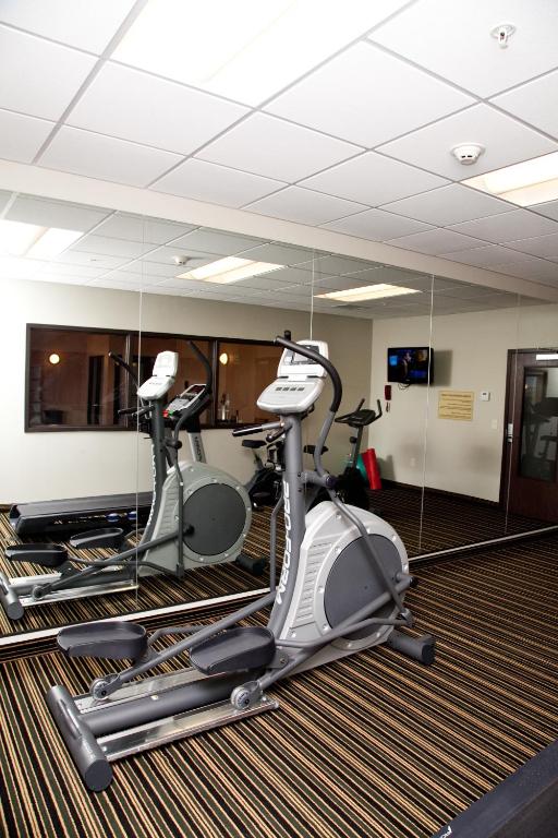 a gym with two exercise bikes and a mirror at Baymont by Wyndham Rapid City in Rapid City