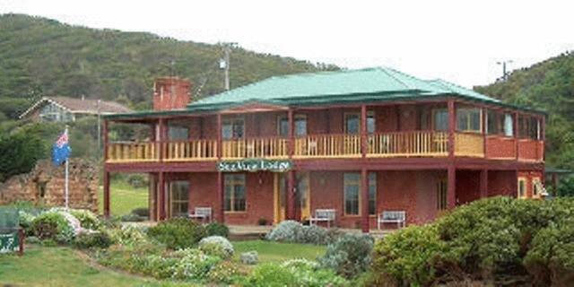 a large house with a red roof on top of it at Cape Bridgewater Seaview Lodge in Cape Bridgewater