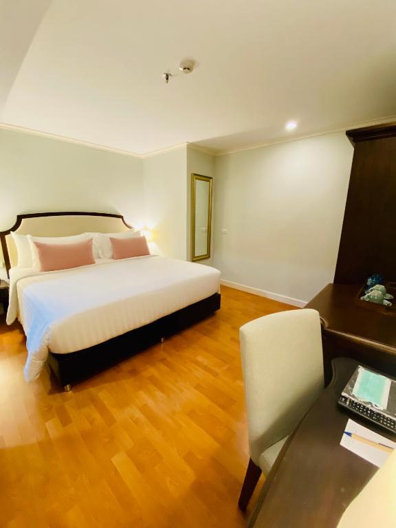 A bedroom view pairs the large bed with a dedicated desk and chair.