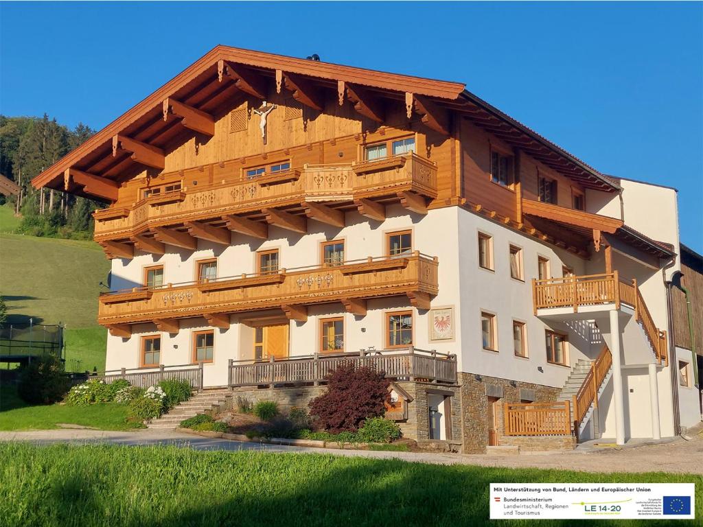 a large building with wooden balconies on it at Erbhof Fritzing in Ebbs