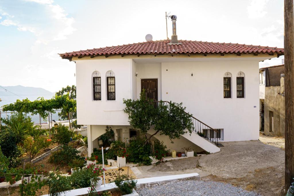 a white house with a red roof at EMPHASIS Traditional House 