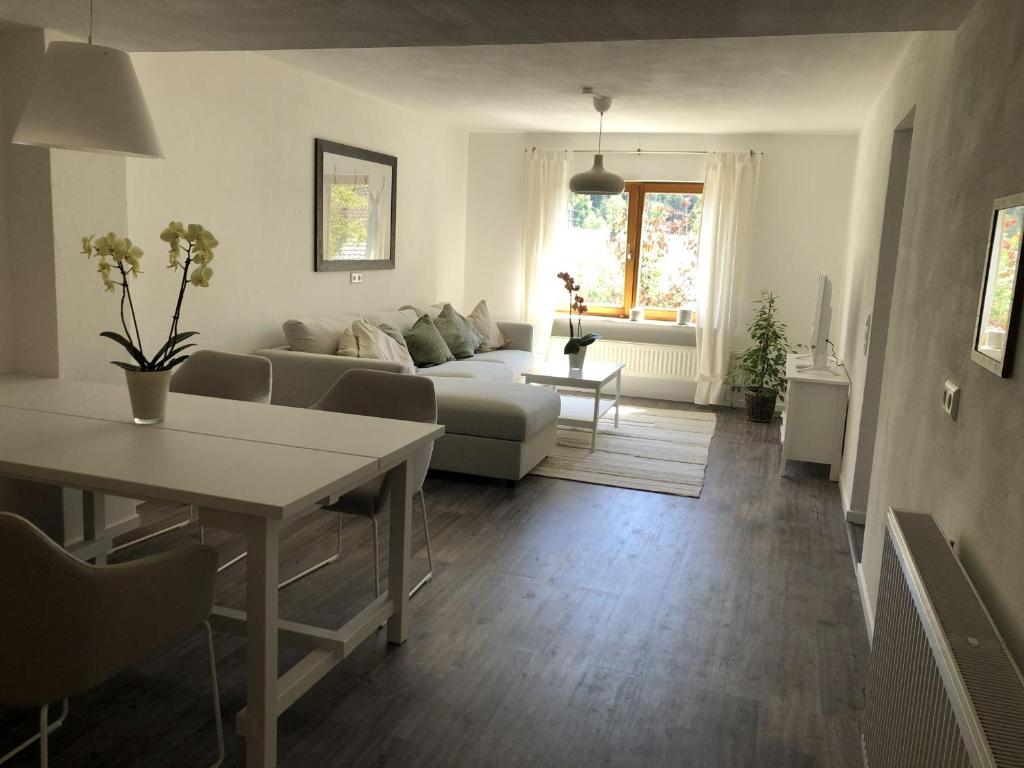 a living room with a couch and a table at Ferienwohnung Am Sonnenhang in Enzklösterle