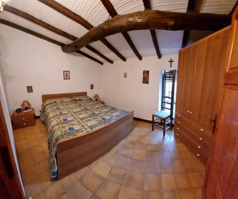 1 dormitorio con 1 cama y 1 silla en una habitación en monte penna, en Cardoso