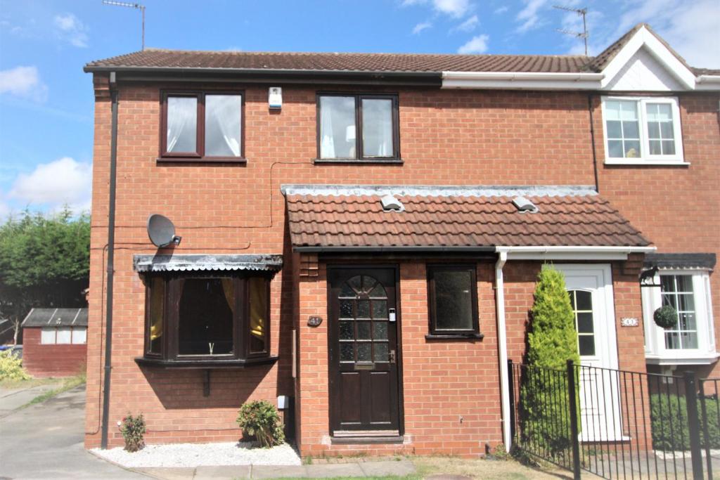 a red brick house with a black door at 3 Bed House - Garden & Parking - Quiet Cul De Sac in Doncaster