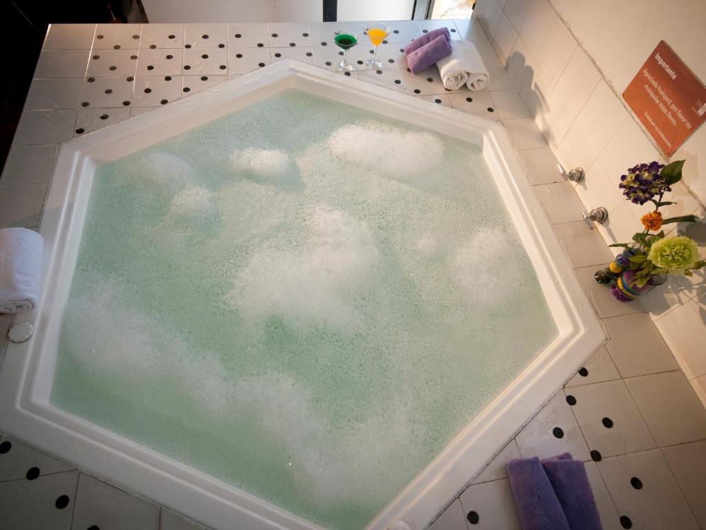 a bath tub filled with water with clouds in it at Armenia Hotel in Armenia