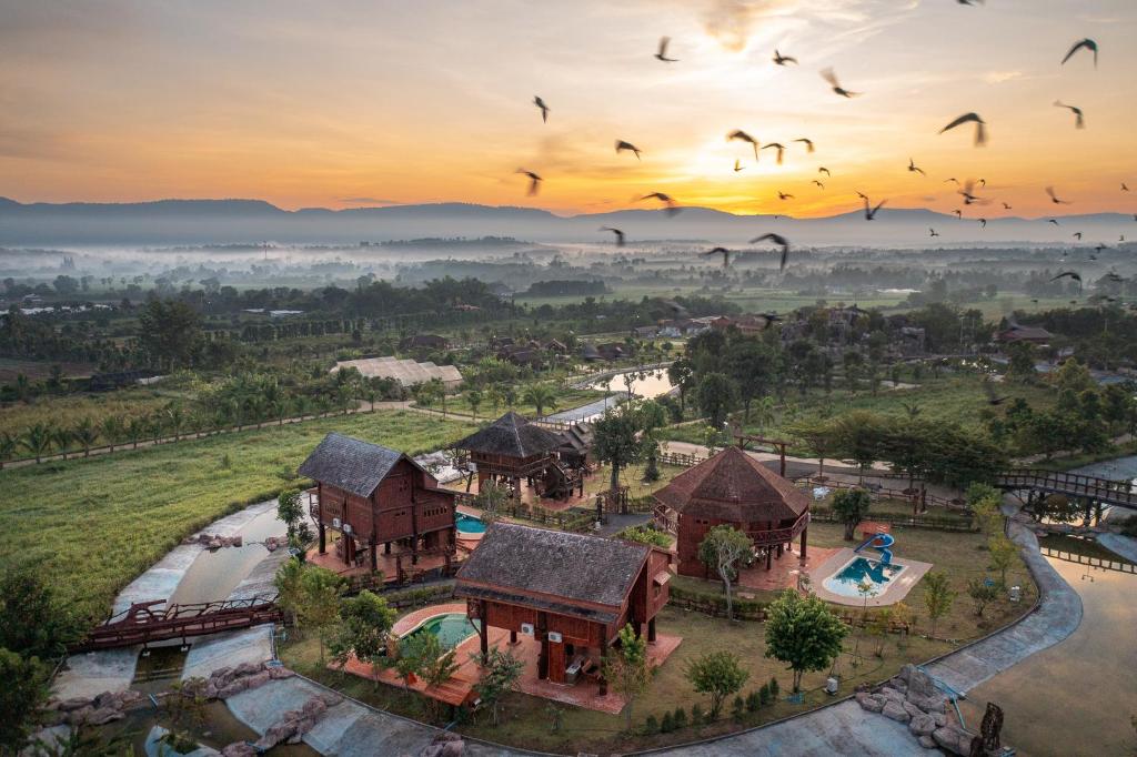 an aerial view of a resort with birds flying overhead at Tayama Farm Khaoyai in Nakhon Ratchasima