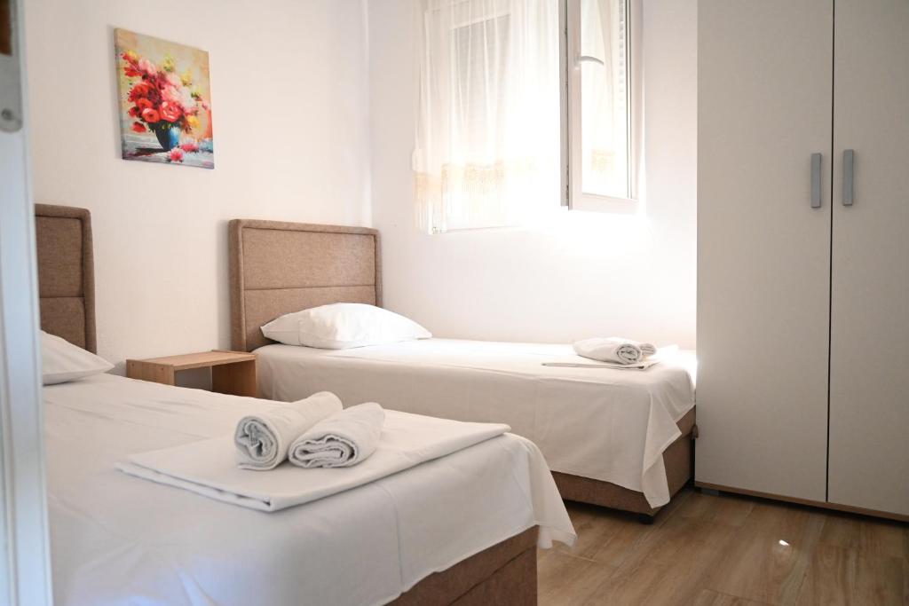 a room with two beds with towels on them at Đuričić Apartmani in Budva