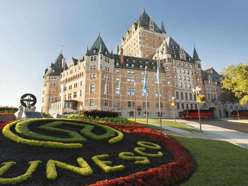 a large building with a clock on the front of it at Fairmont Le Chateau Frontenac in Quebec City