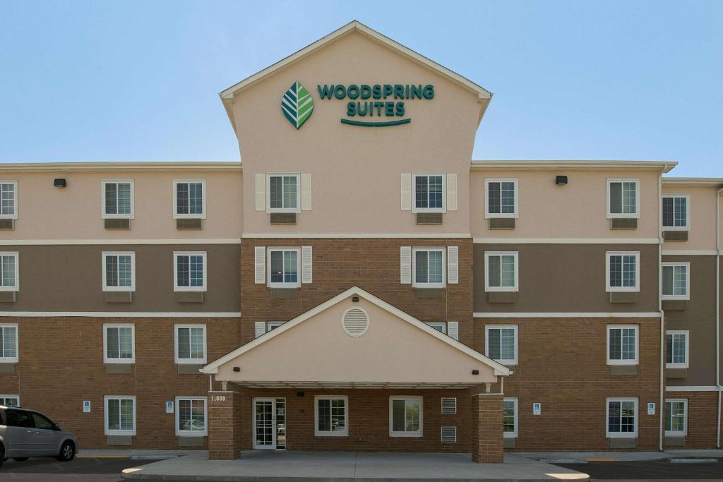 a building with a sign on top of it at WoodSpring Suites Broken Arrow in Tulsa