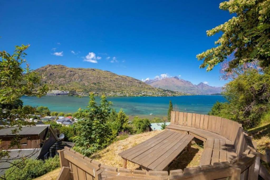 a view of a lake from a fence at Alpine Escape - Elevated Views with Spa in Queenstown