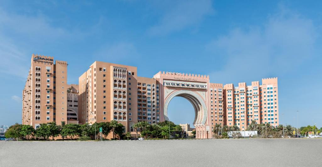a large building with a large clock on it at Oaks Ibn Battuta Gate Dubai in Dubai