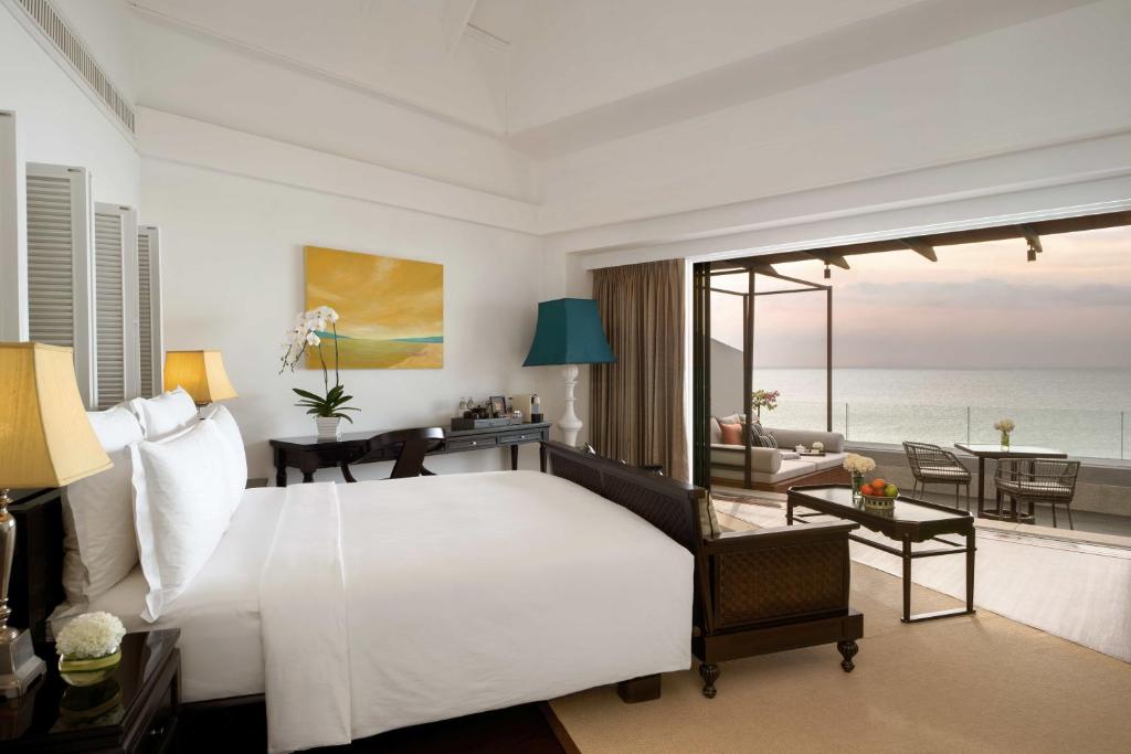 a hotel room with a large bed and a large window at InterContinental Koh Samui Resort, an IHG Hotel - SHA Extra Plus in Taling Ngam Beach