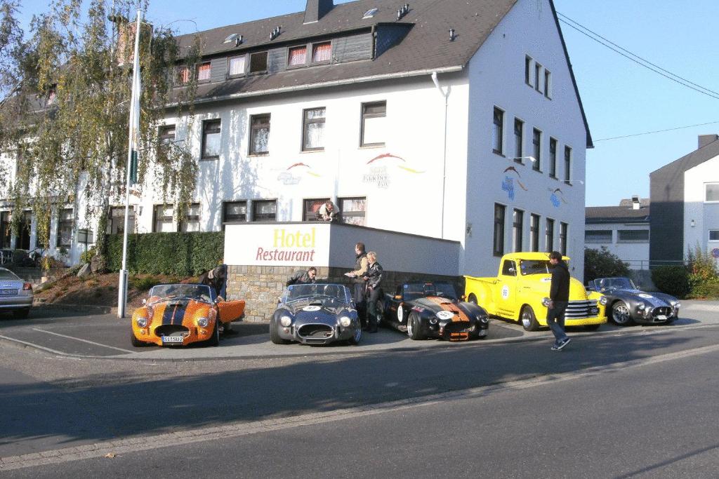 a group of cars parked on the side of a street at Hotel Laacher Lay in Mendig