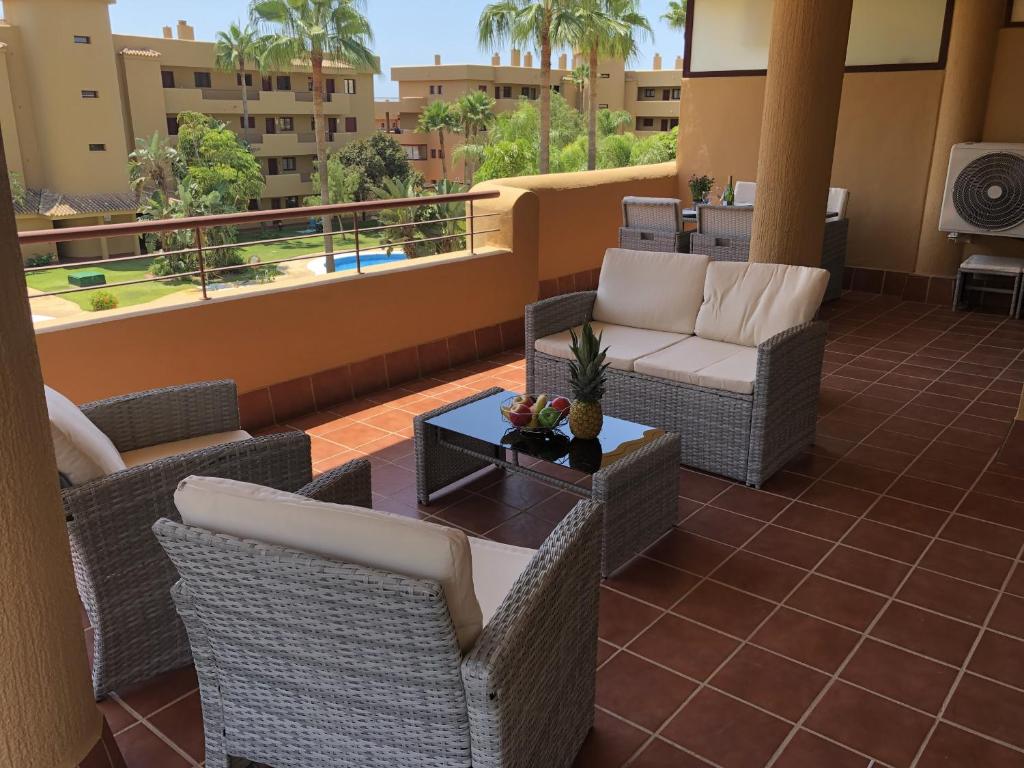 a patio with chairs and a table on a balcony at La Cala Azul 2 bedroom apartment with big sunny terrace & walking distance to all the amenities - costa del sol in La Cala de Mijas
