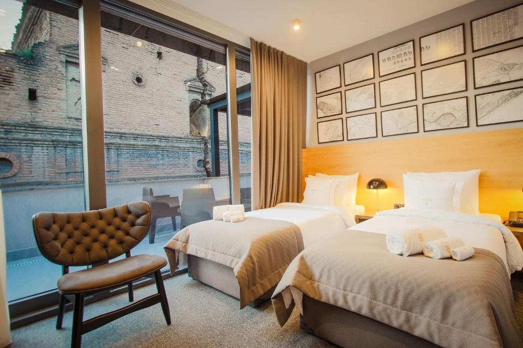 Postel nebo postele na pokoji v ubytování Hotel Tuta