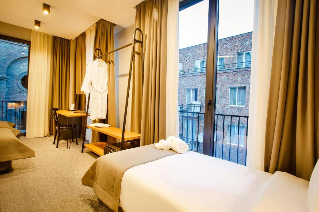 Postel nebo postele na pokoji v ubytování Hotel Tuta