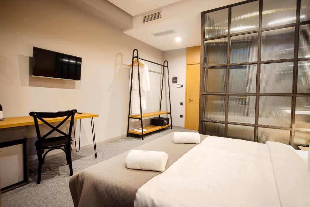 Postel nebo postele na pokoji v ubytování Hotel Tuta
