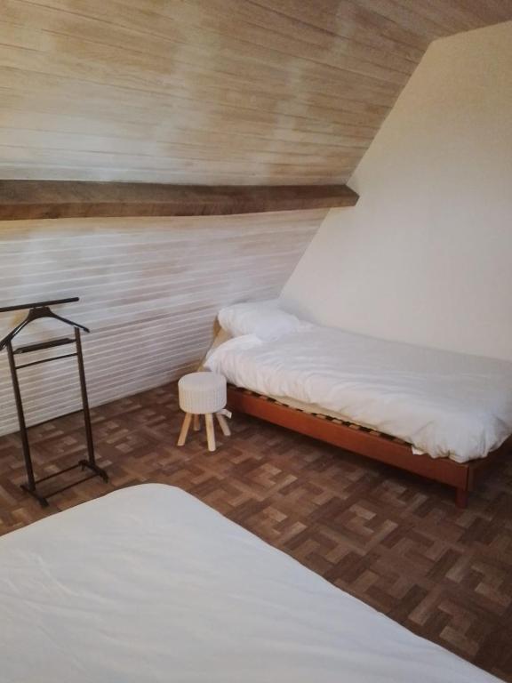 a bedroom with a bed and a table in a room at Maison Marilene in Ajat
