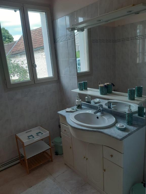 a bathroom with a sink and a mirror at Maison Marilene in Ajat