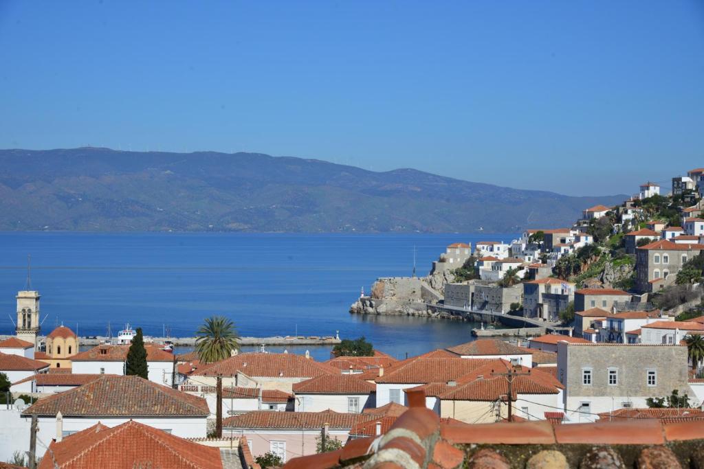 a view of a town with a body of water at Hydra town, Relaxing patio Panoramic sea view in Hydra