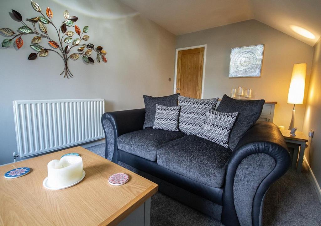 a living room with a couch and a table at Modern Apartment Sherburn In Elmet in Sherburn in Elmet