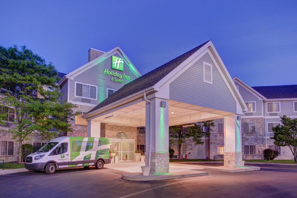 a white van parked in front of a building at Holiday Inn Milwaukee Airport by IHG in Milwaukee