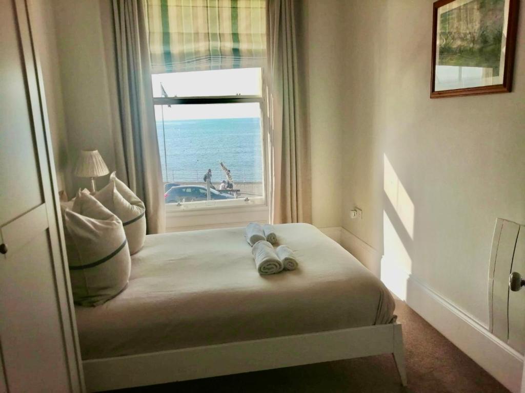 a bedroom with a bed with a view of the ocean at Seaside Apartment in Aberystwyth
