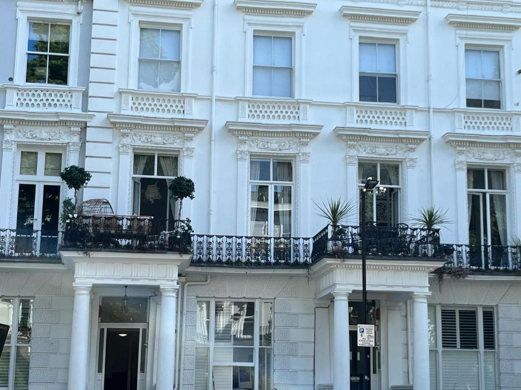 a white building with balconies on the side of it at 2-4 bedroom 2 roof terraces prime Notting Hill in London