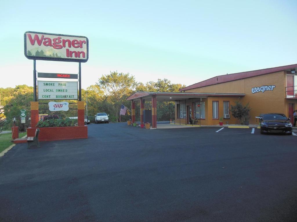 a wenger inn sign in front of a gas station at Wagner Inn in Eureka Springs