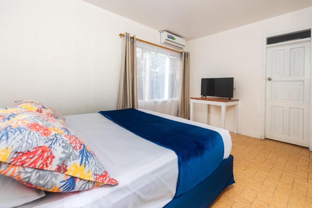 Postel nebo postele na pokoji v ubytování Hostal North Seymour