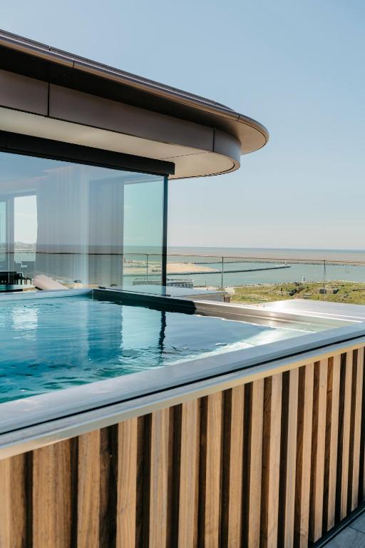 a swimming pool with a view of the ocean at appartement sea view in Ostend
