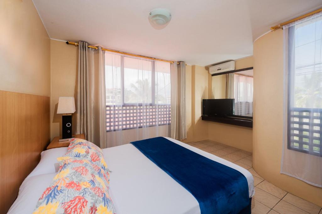 Postel nebo postele na pokoji v ubytování Hostal North Seymour
