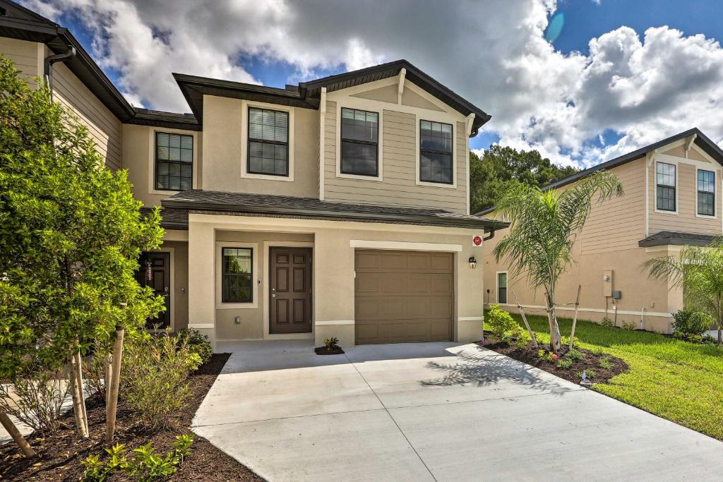 a house with a garage in front of it at Brand New Fort Myers Townhome Community Pool in Fort Myers