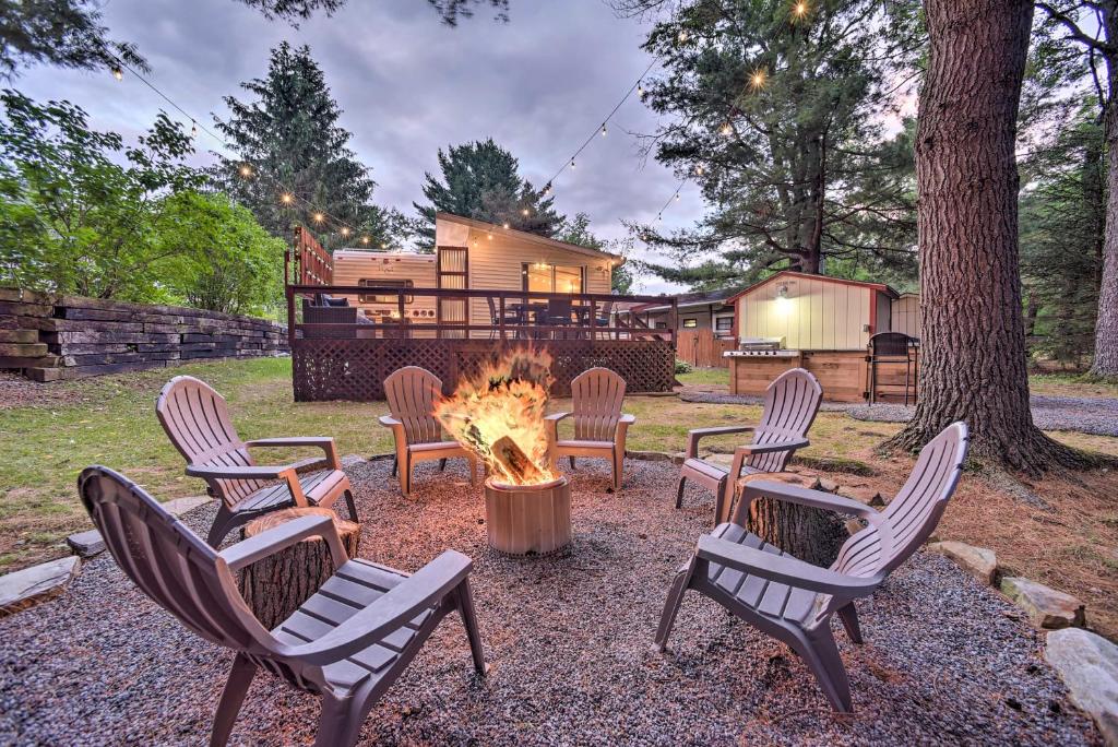 a group of chairs around a fire pit in a yard at Glamping Getaway in Woodstock Lake Campground 