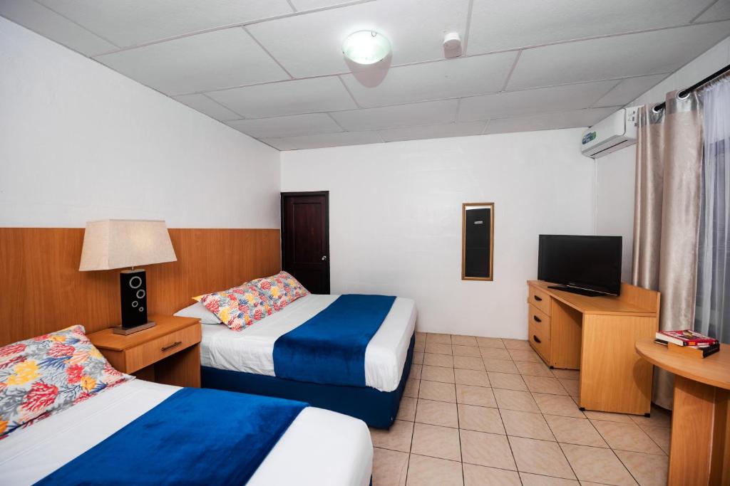 Postel nebo postele na pokoji v ubytování Hostal North Seymour