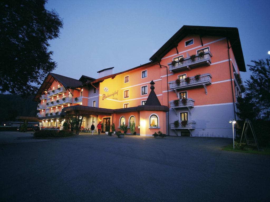 a large building is lit up at night at Hotel Pachernighof in Velden am Wörthersee