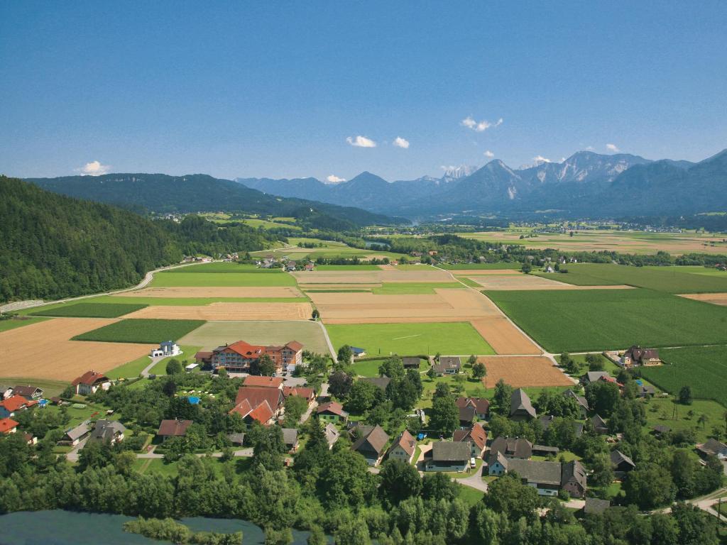 an aerial view of a village in the mountains at Hotel Pachernighof in Velden am Wörthersee