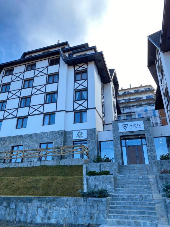 a white building with stairs in front of it at Duplex Vidik B30 - 85m2 in Kopaonik