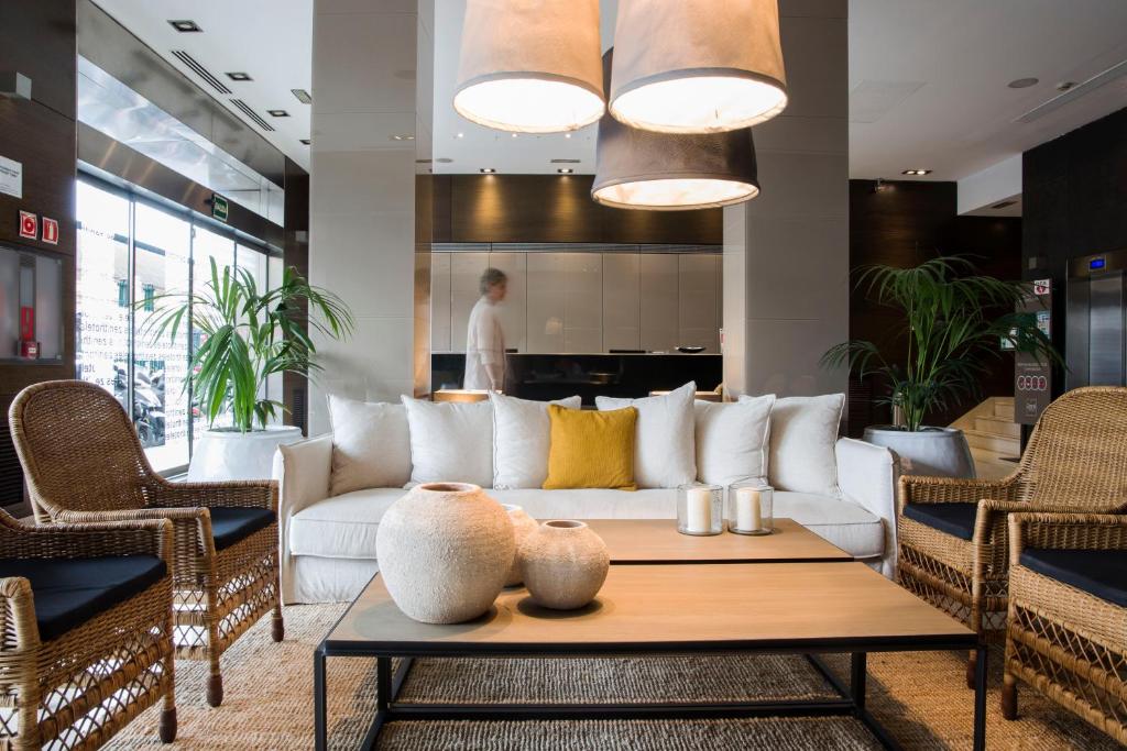 a living room with a white couch and a table at Zenit Valencia in Valencia