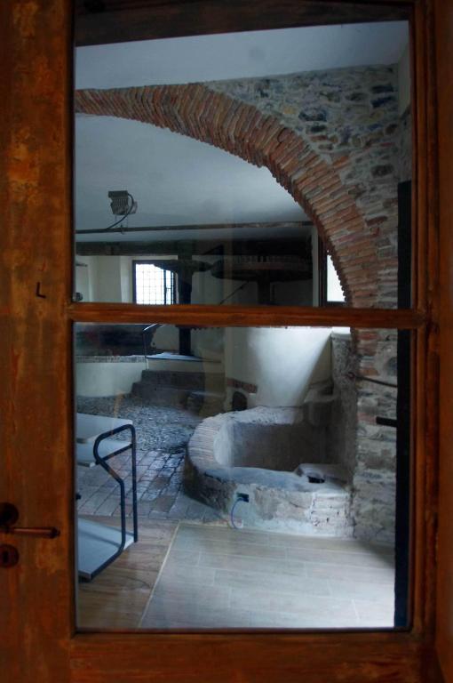 a view of a room through a glass door at Il Mulino del Castello in Garlenda