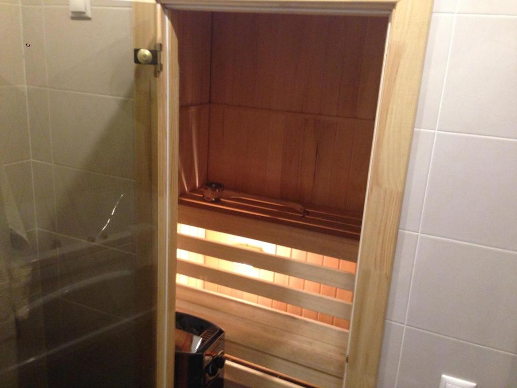 a shower with a glass door in a bathroom at History Hotel in Vologda