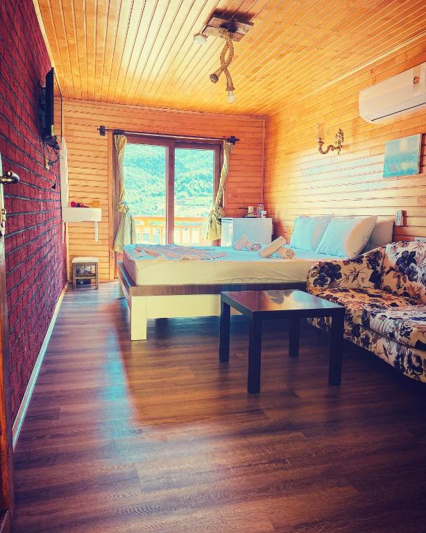 a living room with a bed and a couch at 7 Green Adrasan in Adrasan