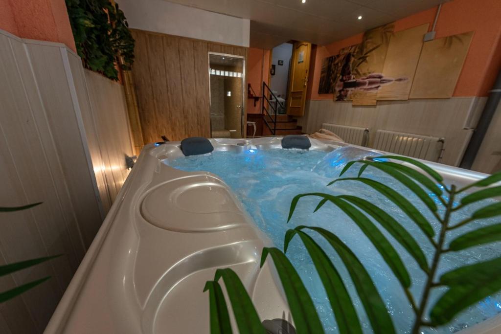 a bath tub filled with blue water in a bathroom at Los Valles & Spa in Pepino