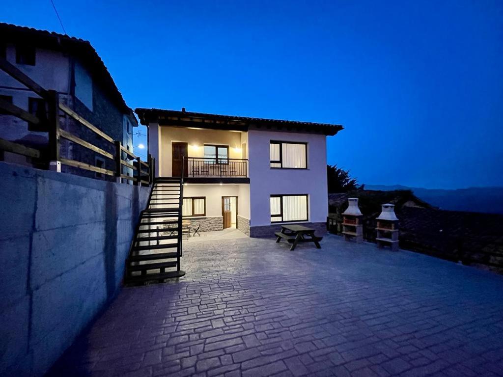 a large house with a staircase in front of it at tiu Enrique 5 in Cangas de Onís