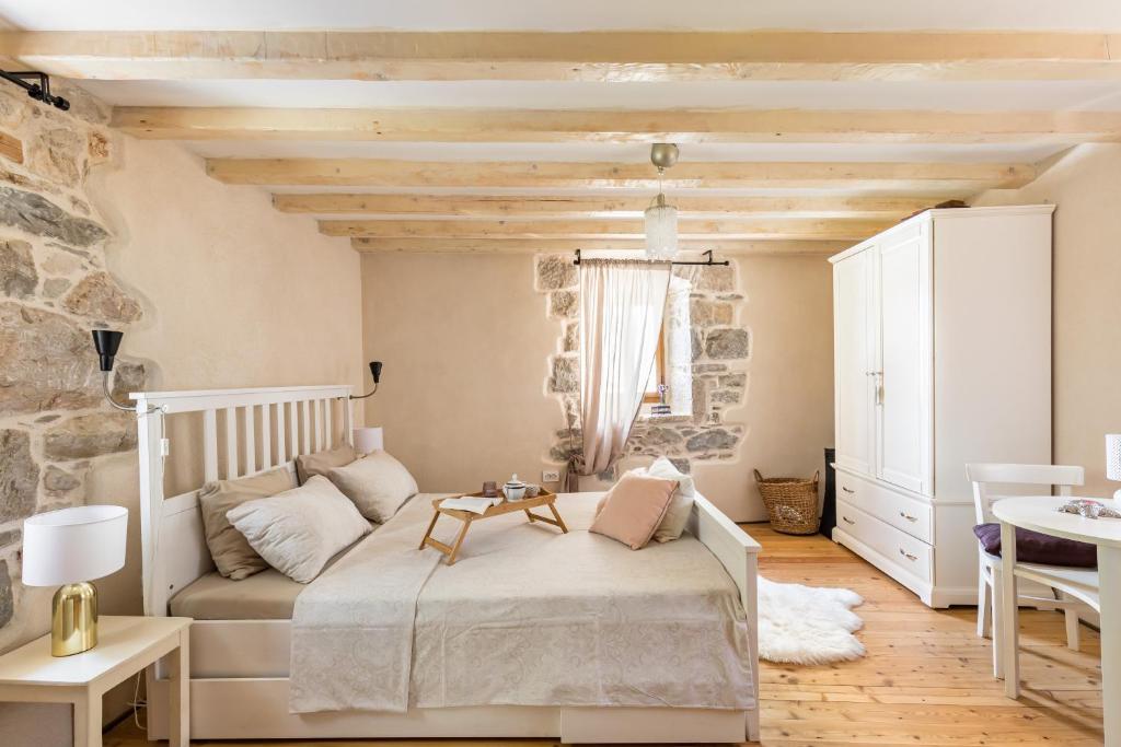 a bedroom with a bed and a stone wall at Holiday Home Vintage in Split