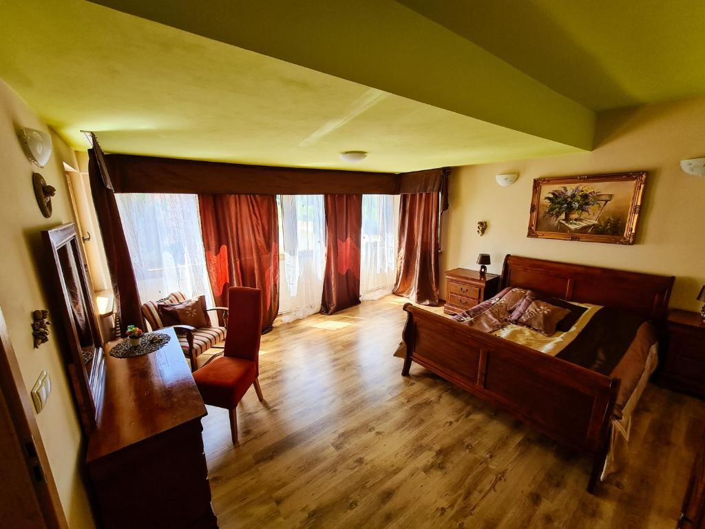 a living room with a couch and a table at Apartament Anielski E.D. Angelo in Duszniki Zdrój