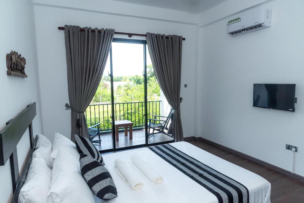 Postel nebo postele na pokoji v ubytování Black Mustang Hotel
